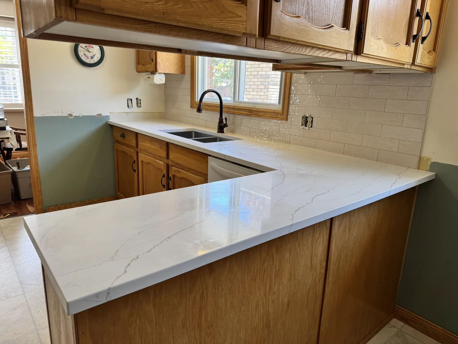 Quartz counters and a new backsplash fitted to existing oak cabinets