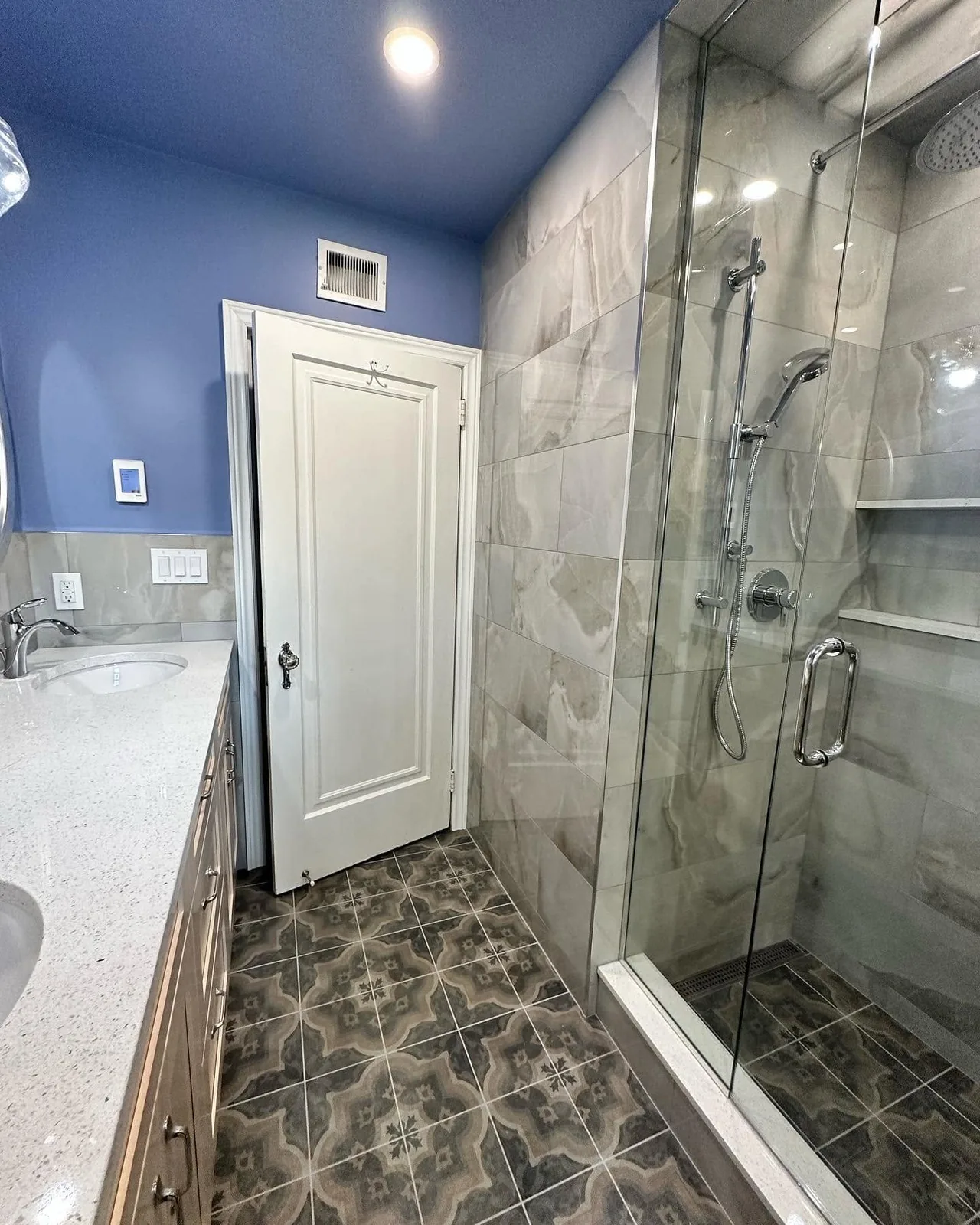 The finished bathroom with patterned floor tile, looking through to the shower