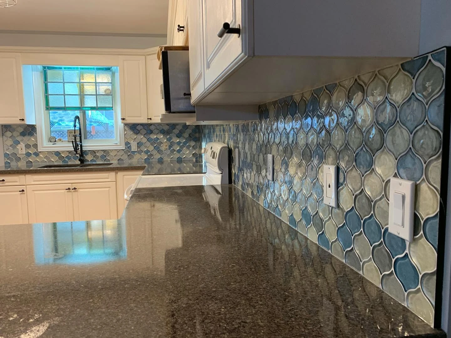 Blue and grey arabesque glass tile backsplash