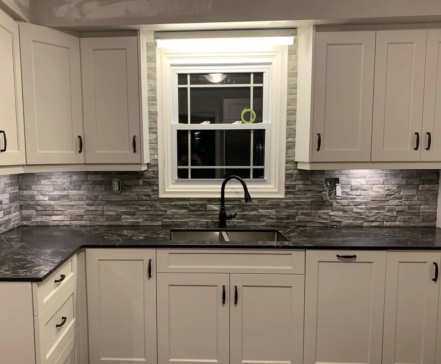 The finished kitchen, split face stone run the length of the backsplash