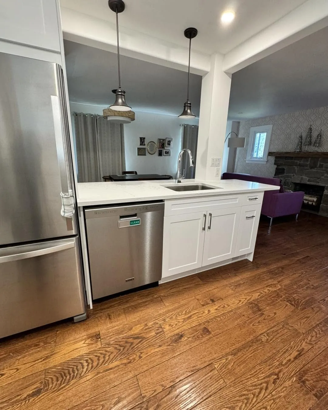 White shaker kitchen open to the living room