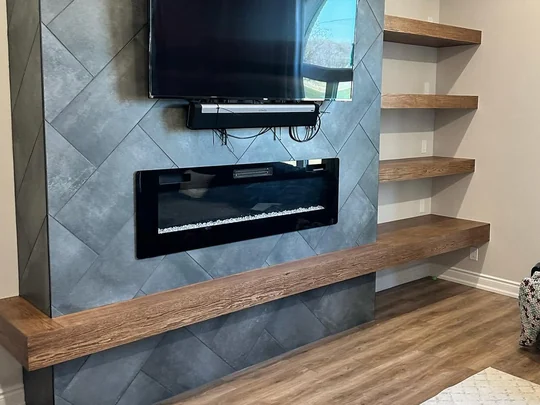 Solid oak floating shelves run across a feature wall
