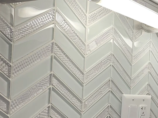 White chevron mosaic tile backsplash